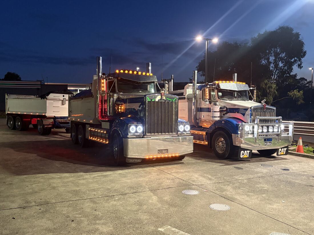 Prime Excavation fleet lit up at the depot after dark